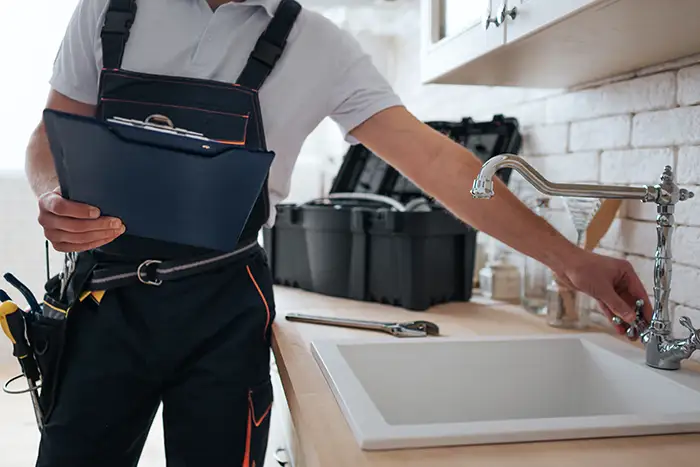 Plumber working on a kitchen sink