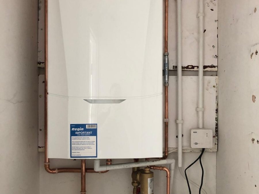 Ideal combi boiler installed in a cupboard with new copper pipework and condensate pump