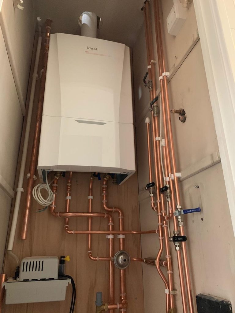 New boiler with neatly clipped copper pipework and valves