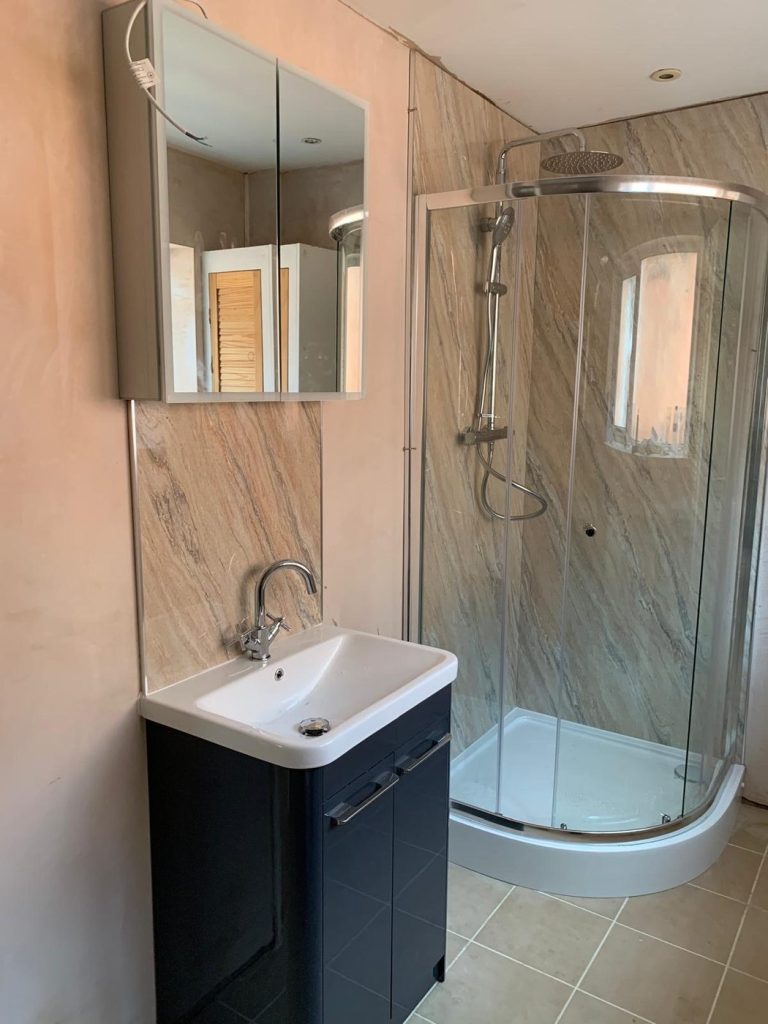 Bathroom installation with quadrant shower enclosure and vanity unit