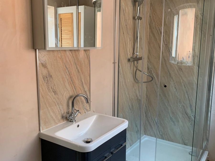 Bathroom installation with quadrant shower enclosure and vanity unit