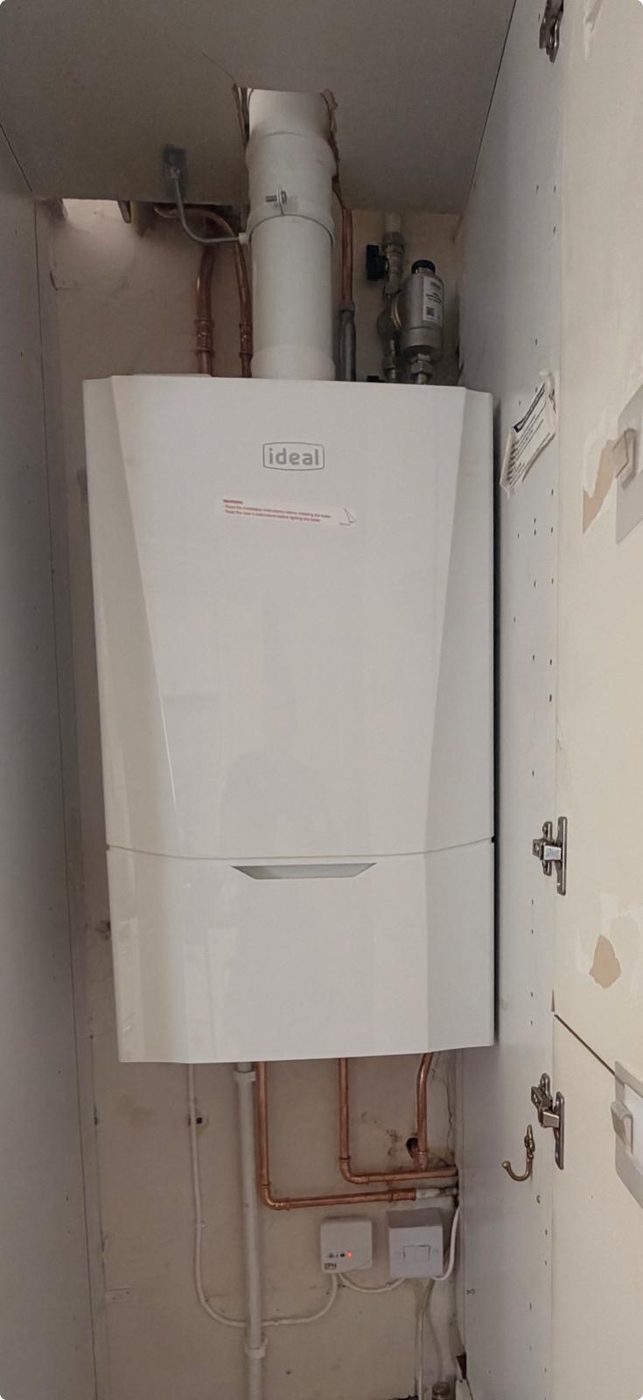Ideal boiler with vertical flue installed in a cupboard